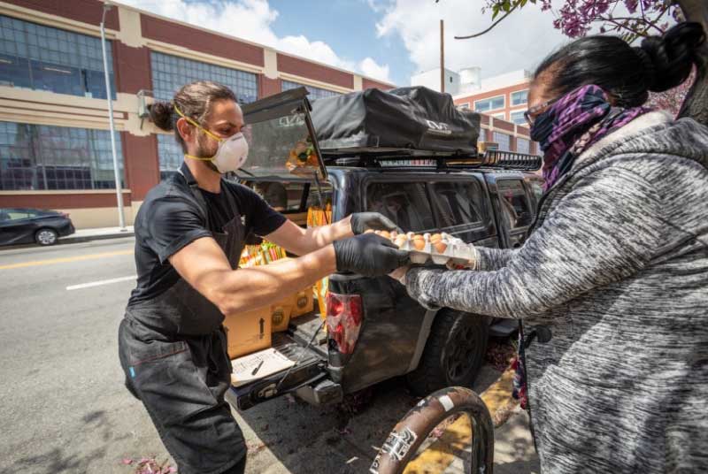 A man donating food to a woman